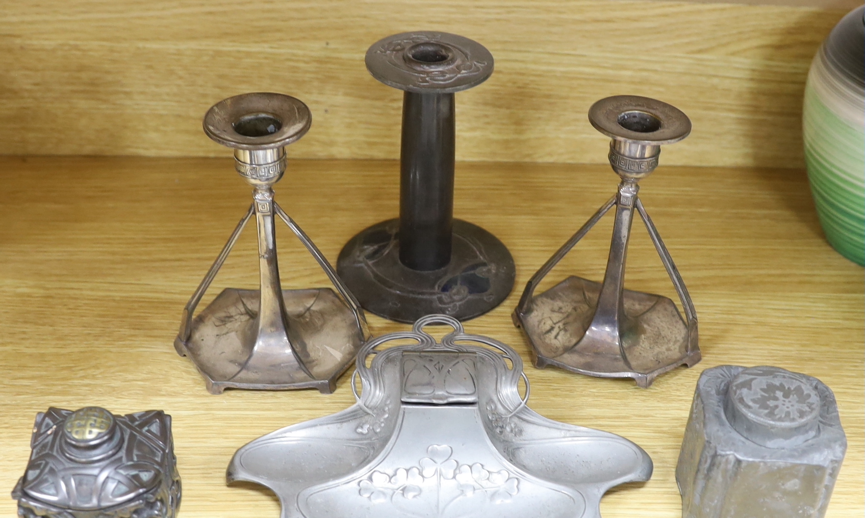 Art Nouveau pewter consisting:- an Orivit two handled tray, pattern 2967, a pair of candlesticks, a single enamel candlestick, a small tray embossed with an infant girl, a WMF inkstand and three other items (9), tray 54c